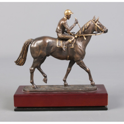 51 - A Cameron Sculptures small bronze model of a jockey and racehorse with gilt detailing.