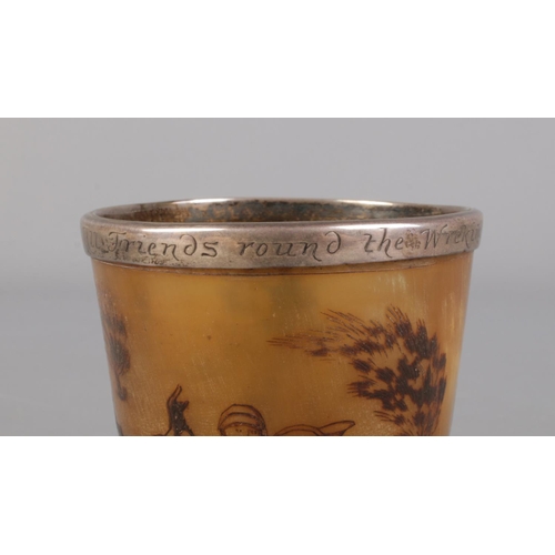 62 - Two white metal mounted horn hunting cups. One carved with a fox hunting scene with inscription to r... 