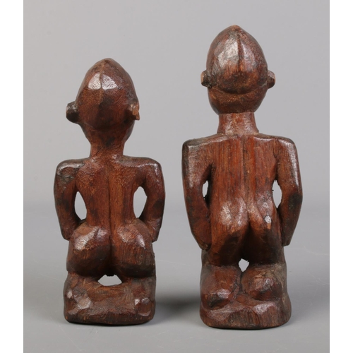 69 - A pair of carved African tribal figures, male and female form.