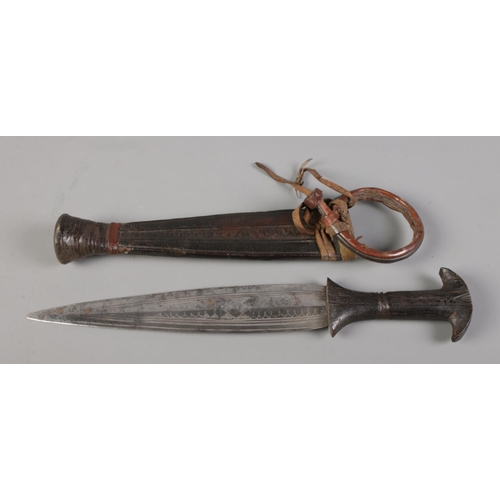 72 - An African tribal double edge dagger in scabbard, possibly Catawiki tribe, along with a similar smal... 