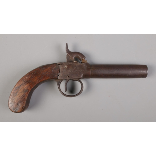 74 - A 19th century percussion cap pistol with screw off barrel and walnut grip.