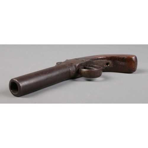 74 - A 19th century percussion cap pistol with screw off barrel and walnut grip.