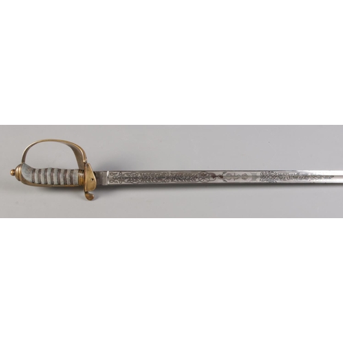 76 - A Royal Naval Officers sword in leather and brass scabbard belonging to Captain Samuel Charles Taylo... 