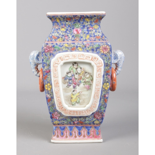 87 - A Chinese twin handled vase decorated in coloured enamels with panels depicting children at play. Be... 