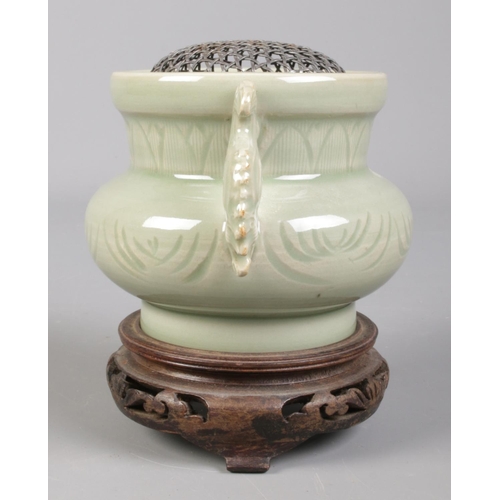 88 - A Chinese celadon censor, with silver meshed inset, raised on carved hardwood stand. Total height 12... 