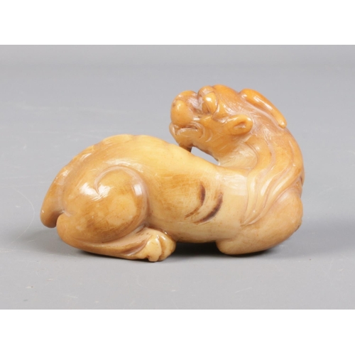 94 - A Chinese carved soapstone figure of a mythical beast. Height 3cm, Length 6cm.