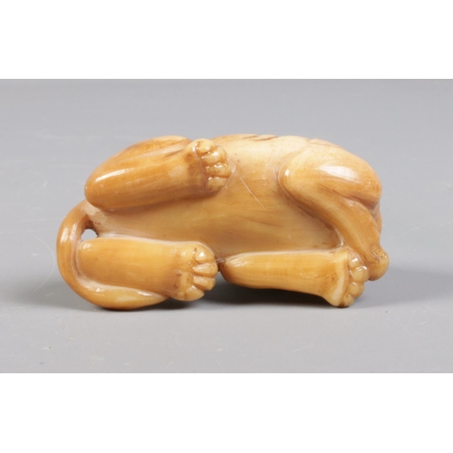 94 - A Chinese carved soapstone figure of a mythical beast. Height 3cm, Length 6cm.