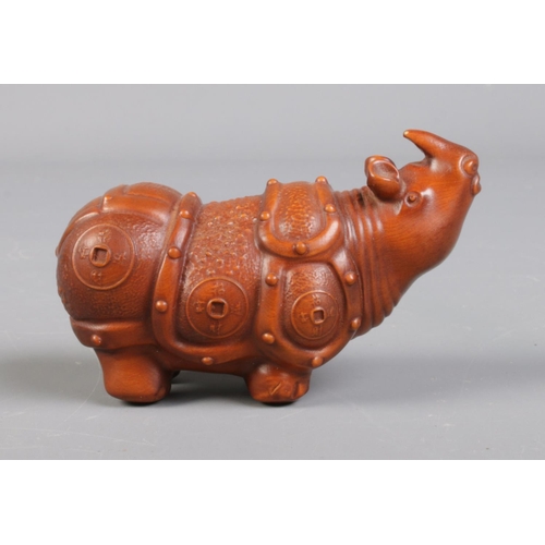 95 - A Chinese carved boxwood figure of a rhino. Height 4cm, Length 7cm.