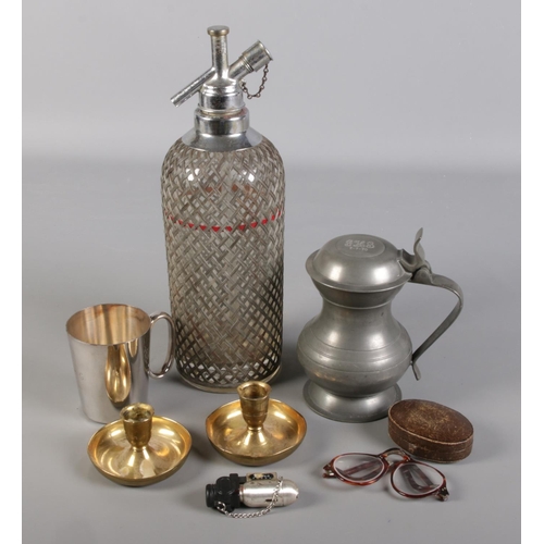 302 - A small selection of collectables. To include a Sparklets of London mesh Soda Siphon, a pair of bras... 