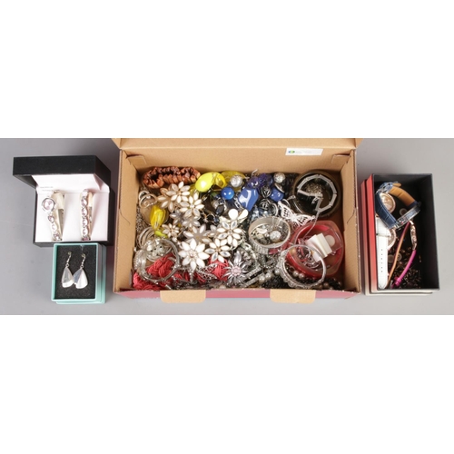 120 - A box of assorted costume/fashion jewellery; mainly earrings, watches and bangles etc.