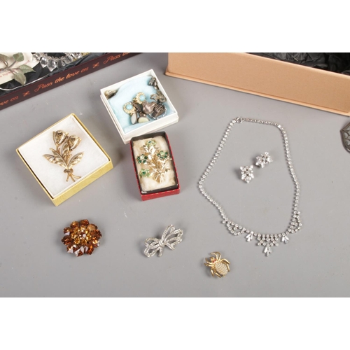 134 - A collection of vintage costume jewellery. To include brooches, necklaces, belt buckles etc