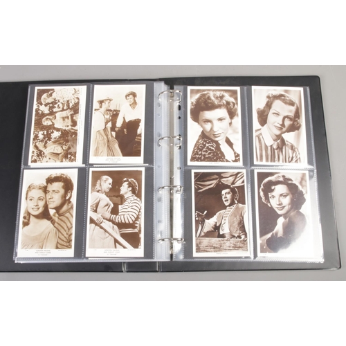 144 - An album of black and white 'Picturegoer' postcards of film scenes and film stars. To include Doris ... 