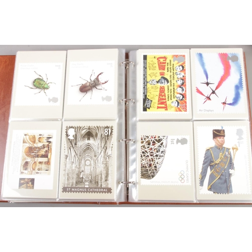 216 - An extensive collection of seven albums of Post Office PHQ Postcards and four albums of stamps. Post... 