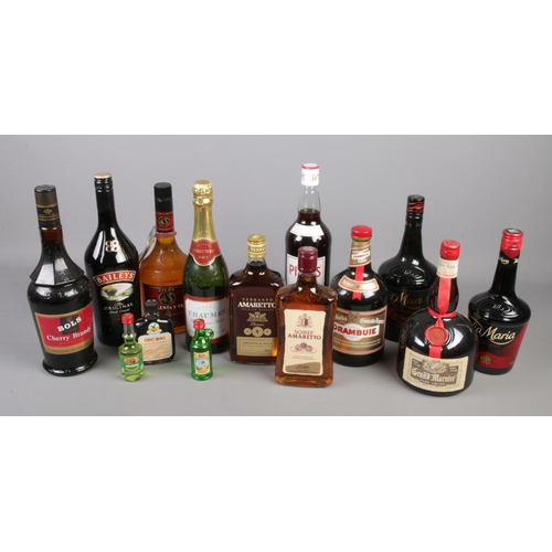 249 - A collection of full and sealed bottles of alcohol. Includes Tia Maria, Pimms, Amaretto etc.