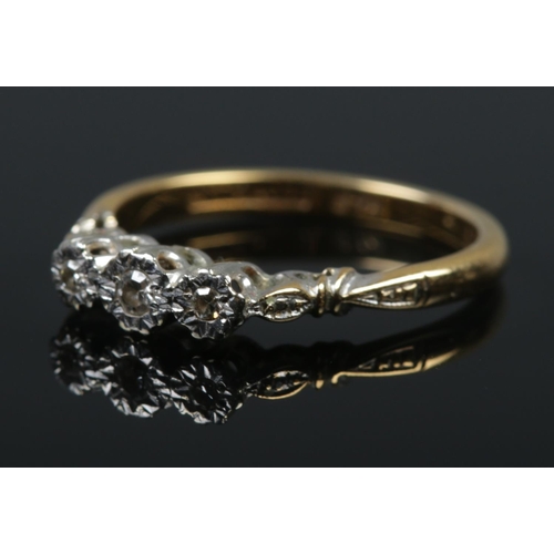 498 - An 18ct gold, platinum and three stone diamond ring. Size N. 2.84g.