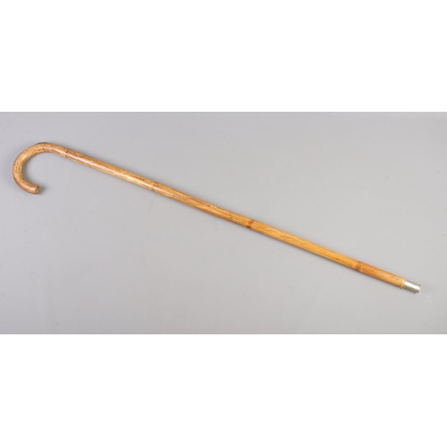 75 - A white metal topped bamboo walking stick, containing horse measurer.