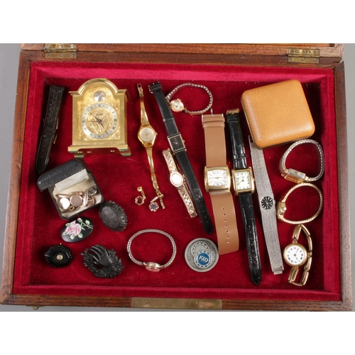 93 - A bijouterie case with contents to include Swiza clock, watches, antique brooches etc.