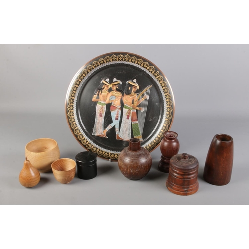 118 - An assortment of wooden treen on an Egyptian tray. To include a Sycamore turned bowl, an Ash cup and... 