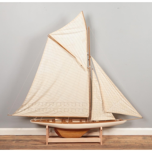 293 - A very large multi-sail model of a yacht, with wooden decking and hull and custom built stand. Heigh... 