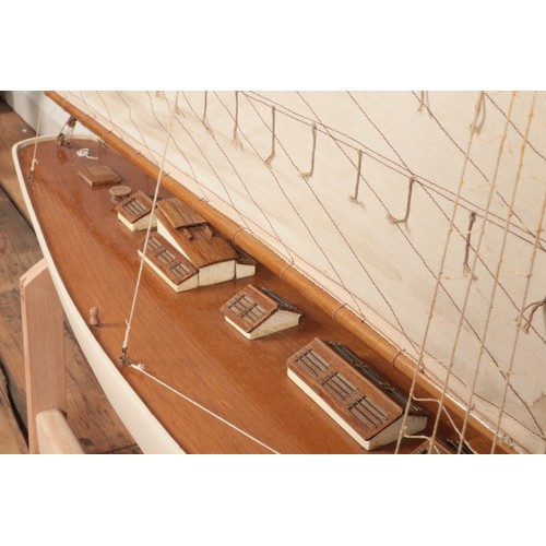 293 - A very large multi-sail model of a yacht, with wooden decking and hull and custom built stand. Heigh... 