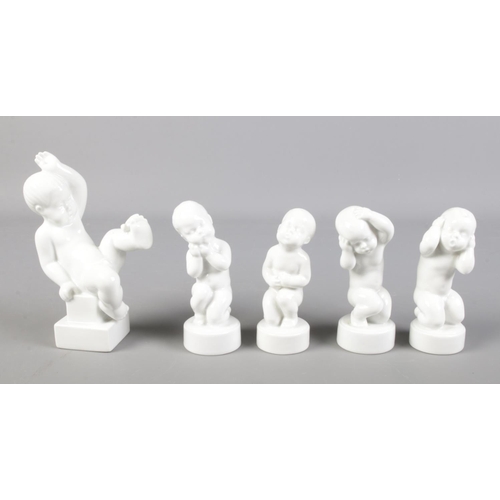 125 - Five Danish B&G (Bing & Grøndahl) porcelain figures of cherubs in various poses. To include the four... 