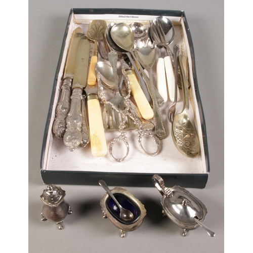 115 - A tray of flatware along with a silver plated cruet set.