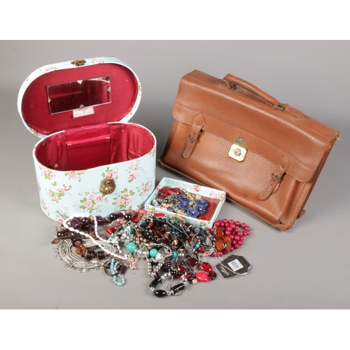 193 - A box containing a Pixie vanity case with contents of costume jewellery, along with a vintage brief ... 