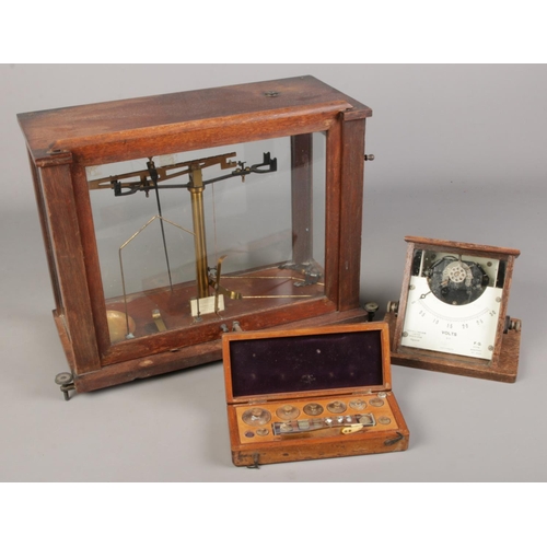 198 - A Griffin and Tatlock voltmeter and chemist scales with weights.