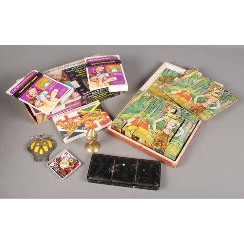 204 - A box of miscellaneous. Includes Victorian puzzle, Walt Disney movie viewer, badges etc.