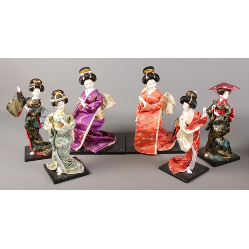 221 - A box of six decorative Geisha dolls on stands.