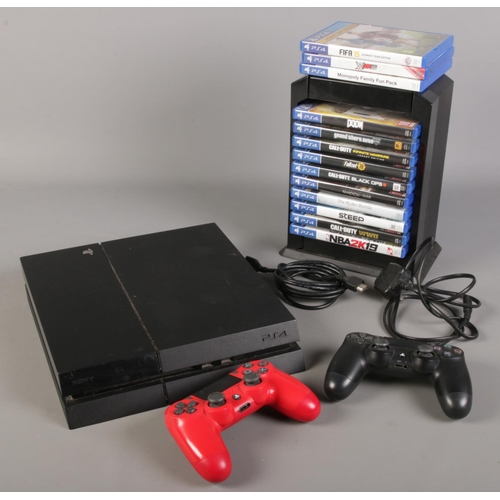 235 - A Sony PlayStation 4 with two wireless dual shock controllers with chargers and quantity of games in... 