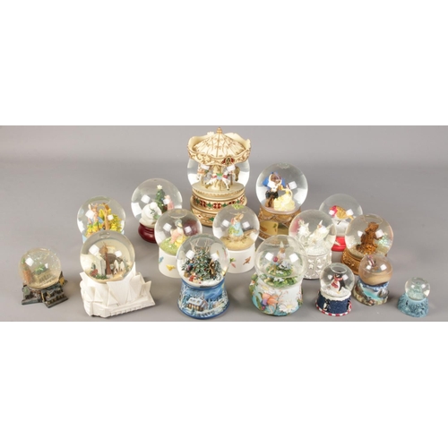 238 - A quantity of snow globes. Including Disney Beauty and the Beast, Beatrix Potter, large carousel exa... 