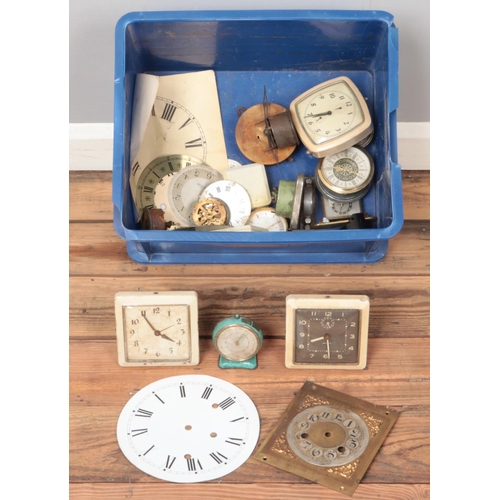 246 - A box of clocks, movements and dials.