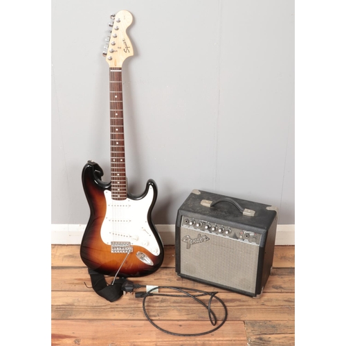 262 - A Squier by Fender electric guitar along with a Fender amplifier.