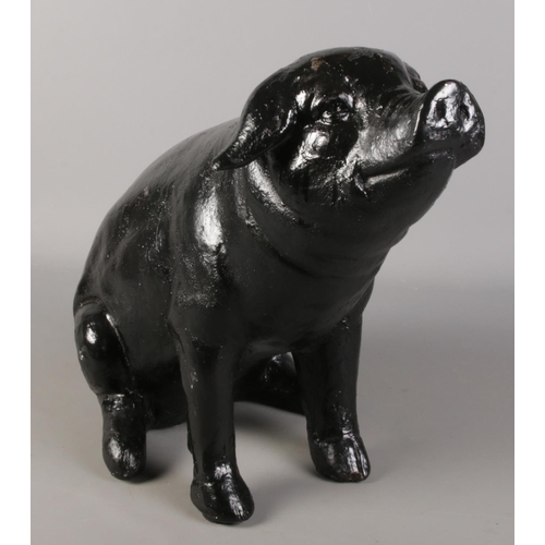 277 - A carbon fibre figure of a seated pig. Height approximately 43cm.