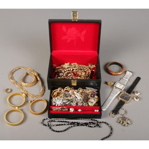 75 - A jewellery box and contents of costume jewellery. Including rings, earrings, necklaces, watches, et... 