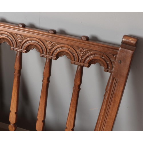 442 - A carved Ercol sofa along with matching armchair. Both with cream upholstery.