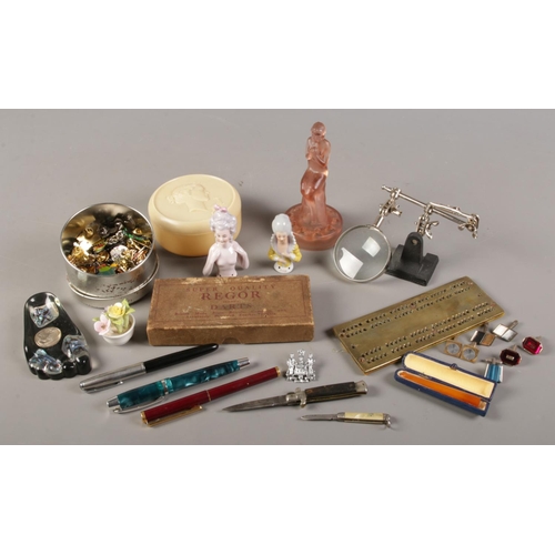 99 - A box of collectables. Includes pen knives, china half dolls, cufflinks etc.