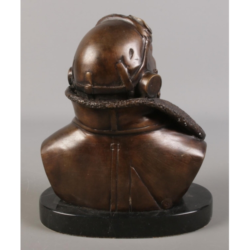 106 - A Bronze bust depicting a fighter pilot, raised on marble base. Signed RS to back. 19cm high.