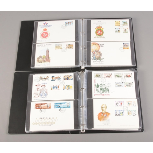 141 - Two albums containing a collection of first day covers, including Isle of Man examples (approximatel... 