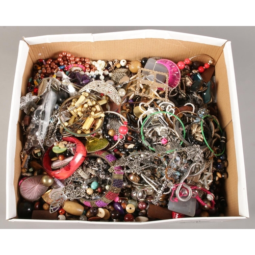 180 - A box of costume jewellery. Including beads, bangles, necklaces, bracelets, etc.