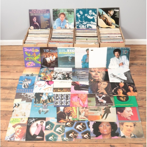 213 - Four large boxes of assorted vinyl records, to include UB40, Lionel Richie, Rod Stewart, Art Garfunk... 