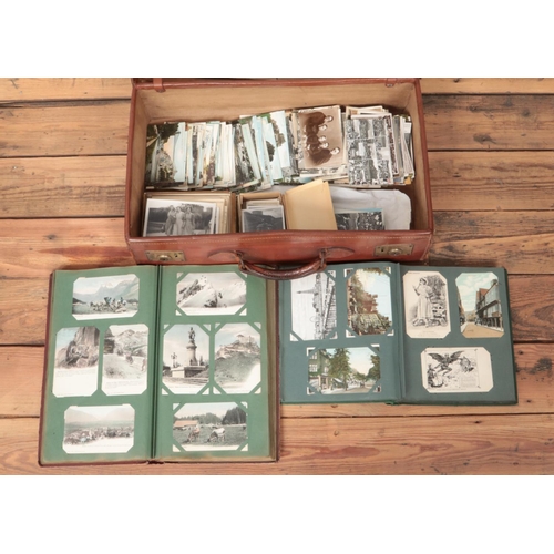 276 - A leather suitcase containing an extremely large collection of vintage world postcards and photograp... 