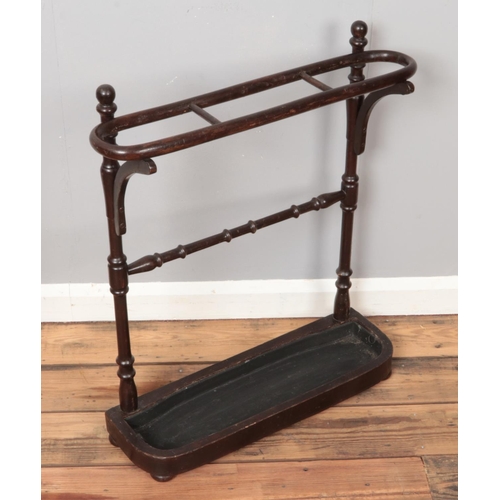 288 - A stained three section stick stand, with turned supports and removable drip tray. Height: 73cm, Wid... 