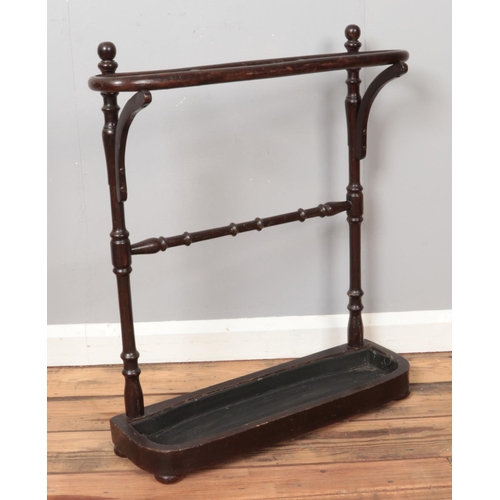 288 - A stained three section stick stand, with turned supports and removable drip tray. Height: 73cm, Wid... 