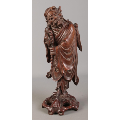 68 - A Chinese carved hardwood figure. 39cm high.