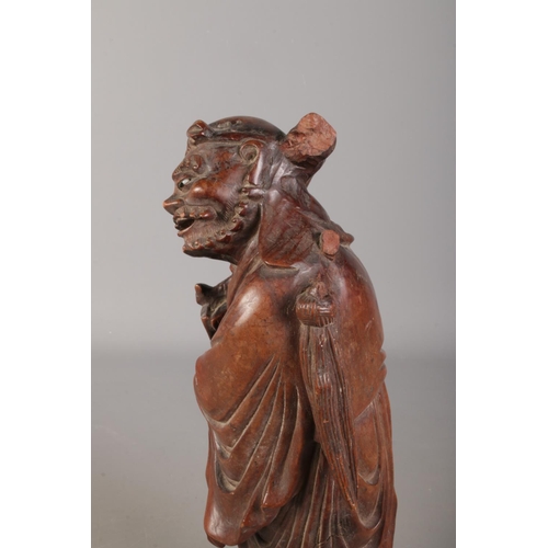 68 - A Chinese carved hardwood figure. 39cm high.