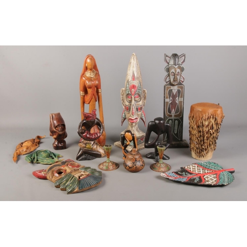 70 - A collection of tribal items, to include decorative mask, small totem and a pair of turned squat can... 