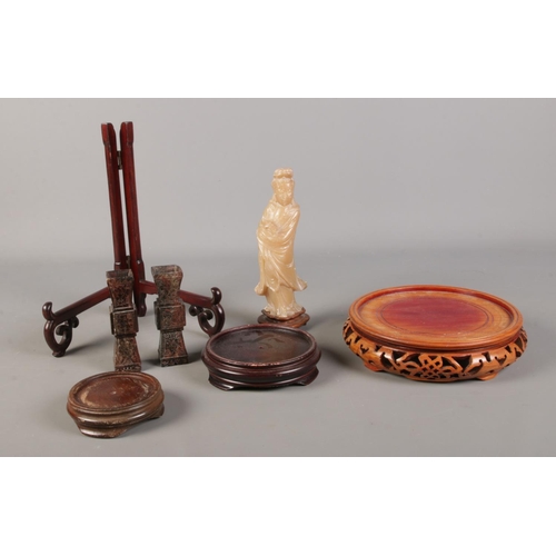 77 - A collection of oriental items, to include carved stands, soapstone figure and hardstone specimen va... 