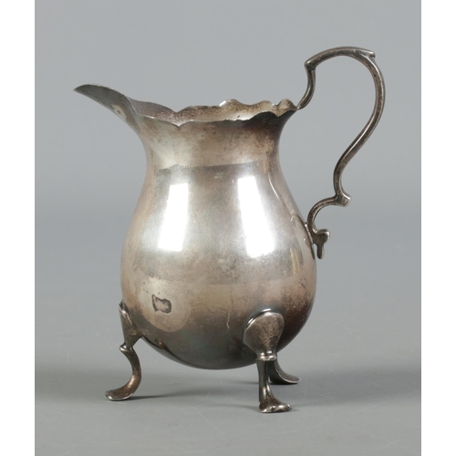 417 - A silver helmet-shaped cream jug, assayed for London, by Charles Boyton & Son Ltd. Total weight: 106... 